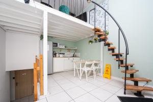a kitchen and dining room with a spiral staircase in a house at S-HE Space - Budget Micro Rooms Kraków in Krakow