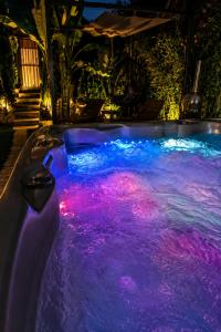 a swimming pool with lights in the water at night at Romantic Mirka Apartment in Sremski Karlovci in Sremski Karlovci