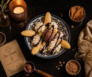 a plate of ice cream and bananas on a table at DAR-VIDA Guesthouse in Imsouane