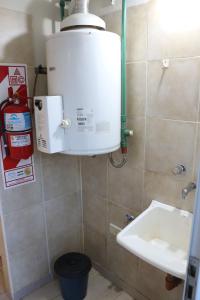 a bathroom with a water heater and a sink at MRU Colón aparts in Colón +29 photos