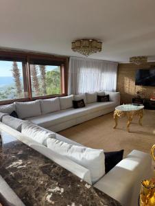 a living room with a large couch and a table at Tanger Achakar in Tangier