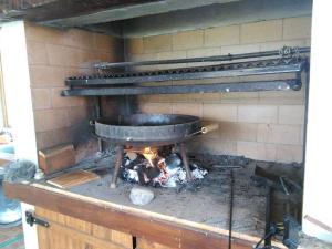 a pot over a fire in a brick oven at Tafi del Valle Casa Kabure in Tafí del Valle