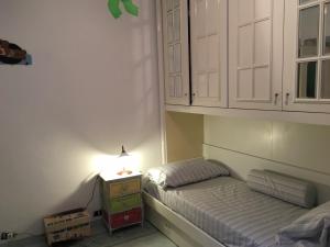 a bedroom with a bed and a night stand with a lamp at La Casa di Zoe in Uscio