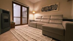 a living room with a couch and a television at Casa da Serra - T1 - Penhas da Saúde in Penhas da Saúde