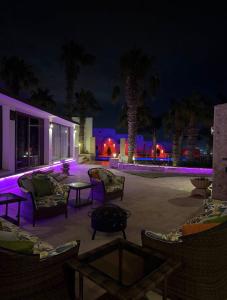 a patio with chairs and a table at night at Tanger Achakar in Tangier