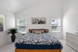 a bedroom with a bed and two windows at Luxury New Build Bright 2BR 2BA Large Backyard in Mission Viejo +19 photos
