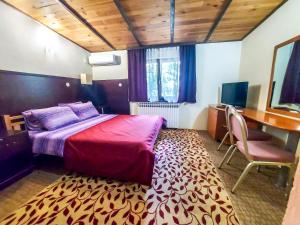 a bedroom with a bed and a desk and a desk at Hotel Rimski Most in Sarajevo
