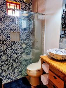 a bathroom with a toilet and a sink and a shower at Coronel's Peak Coffee House in Salento +58 photos