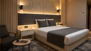 a hotel room with a bed and a chair at Yeşilyurt Park Otel in Çorlu +59 photos