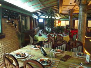 a restaurant with tables and chairs with food on them at Hotel Rimski Most in Sarajevo
