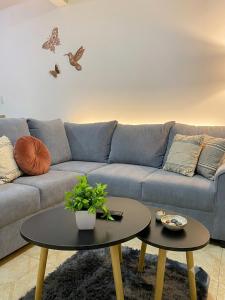 a living room with a blue couch and two tables at Hospedaje Daki in Zacatlán