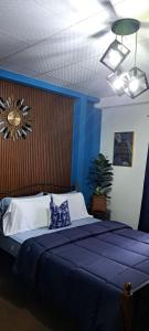 a blue bedroom with a large bed with a blue wall at Cozy Comfy Budget Friendly in San Fernando