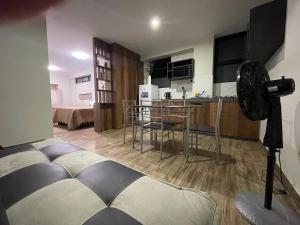 a living room with a kitchen and a room with a camera at Olive Loft - Local Sensory and Boutique Experience in Tacna