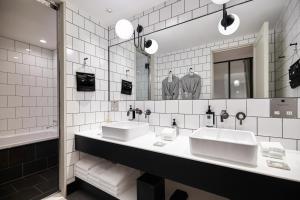 a bathroom with two sinks and a large mirror at TRUNK(HOTEL)CAT STREET in Tokyo +83 photos