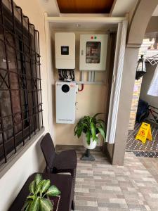 a porch with a refrigerator and a table and chairs at Tiya Cheding Boarding House in Carolina +8 photos