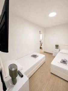 a room with two beds and a flat screen tv at Apartmani Morѐll in Novalja