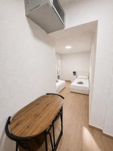 a room with a wooden table and a bed at Apartmani Morѐll in Novalja +30 photos