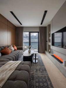 a living room with a couch and a tv at برج داماك الكورنيش - Damac Al-Corniche Tower in Jeddah