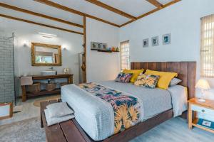 a bedroom with a king sized bed and a bathroom at Breeze Ocean Bungalow Moorea in Moorea