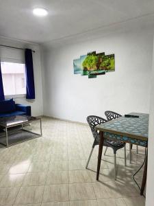 a living room with a table and chairs and a couch at la corniche de tanger in Tangier