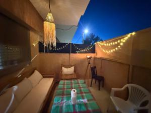 a room with a couch and a table with lights at Saidia appart in Saïdia