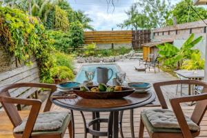 a table with a bowl of fruit on a patio at Breeze Ocean Bungalow Moorea in Moorea