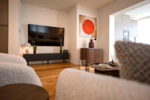a living room with a large flat screen tv at Maslina Residence - Hvar in Hvar +123 photos