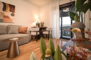 a living room with a couch and a table at Maslina Residence - Hvar in Hvar