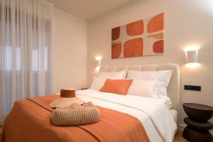 a bedroom with a large bed with a hat on it at Maslina Residence - Hvar in Hvar