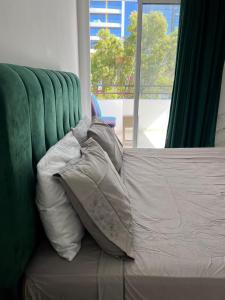 a pile of pillows sitting on a bed with a window at la corniche de tanger in Tangier +6 photos