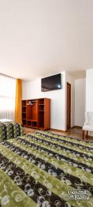 a hotel room with a bed and a couch at Casona Blanca in Arequipa