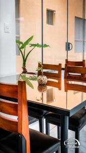 a dining room table with chairs and a plant on it at Casona Blanca in Arequipa