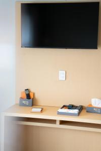 a shelf with a flat screen tv on a wall at Rayya Suites , Invercargill in Invercargill +29 photos