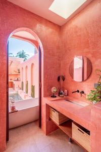 a bathroom with a tub and a sink and a mirror at Villa Solea in Gili Trawangan +19 photos