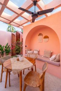 a patio with a table and chairs and a couch at Villa Solea in Gili Trawangan
