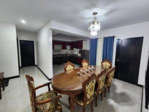 a dining room with a wooden table and chairs at Angeles Private Pool Villa in Angeles