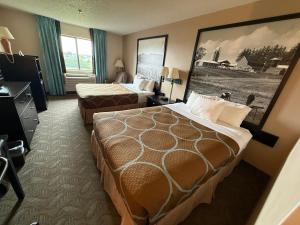 a hotel room with two beds and a window at Dodgeville inn & suites in Dodgeville