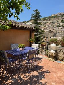 a table and chairs on a patio with a view at Le Lumie in Modica