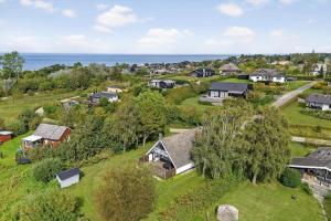 an aerial view of a village with houses and the ocean at FY196-Brenderup-Fyn-Bakkevej-15 in Vedelshave