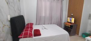 a room with a bed with a red blanket on it at Kitnet na Imbiribeira in Recife