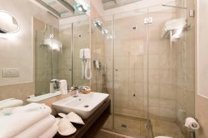 a bathroom with a sink and a shower at Relais Maddalena in Rome