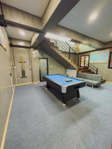 a pool table in a basement with a staircase at NJ HOME Pool Villa in Ban Phe
