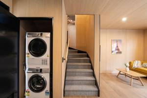 a stairway with a washer and dryer in a house at Ski Villa with Carpark 40, Stylish Alpine Base in Queenstown