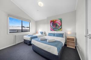 a bedroom with two beds and a window at Sovereign Views Apartments in Ballarat +56 photos