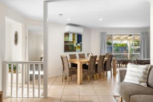 a dining room with a table and chairs at Skippers Place in Noosaville