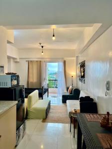 a living room with a couch and a table at D' Cozy Pines Suites in Baguio