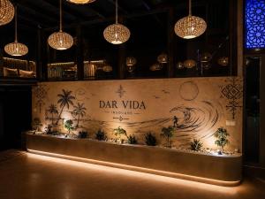 a bar with a sign on the wall of a restaurant at DAR-VIDA Guesthouse in Imsouane