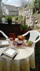 a table with plates of food on top of it at Chez NIKI in Rieutort