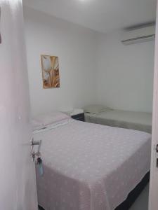 a bedroom with a bed in a white room at Fênix hospedaria in Natal