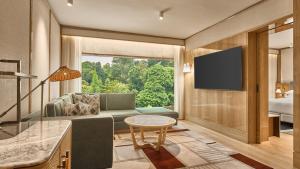 a living room with a couch and a large window at Holiday Inn Singapore Orchard City Centre by IHG in Singapore